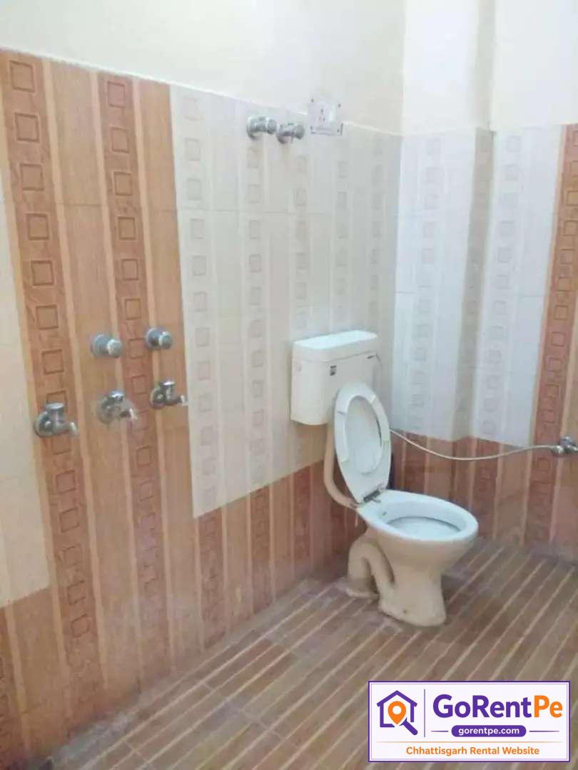Boys PG room for rent in Sarkanda Chowk Bilaspur with attached bathroom, bed, study table, chair, fans, book racks and kitchen facility near Mahamaya Chowk
